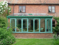 Green Hardwood Conservatory with plant on arches in North Walsham