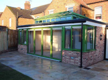 RAL 6025 Green Flat roof Extension with Glass Lantern and Bi Fold Doors